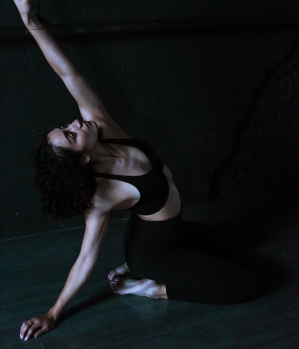 Woman in a dynamic yoga pose against a dark background with lime accents.